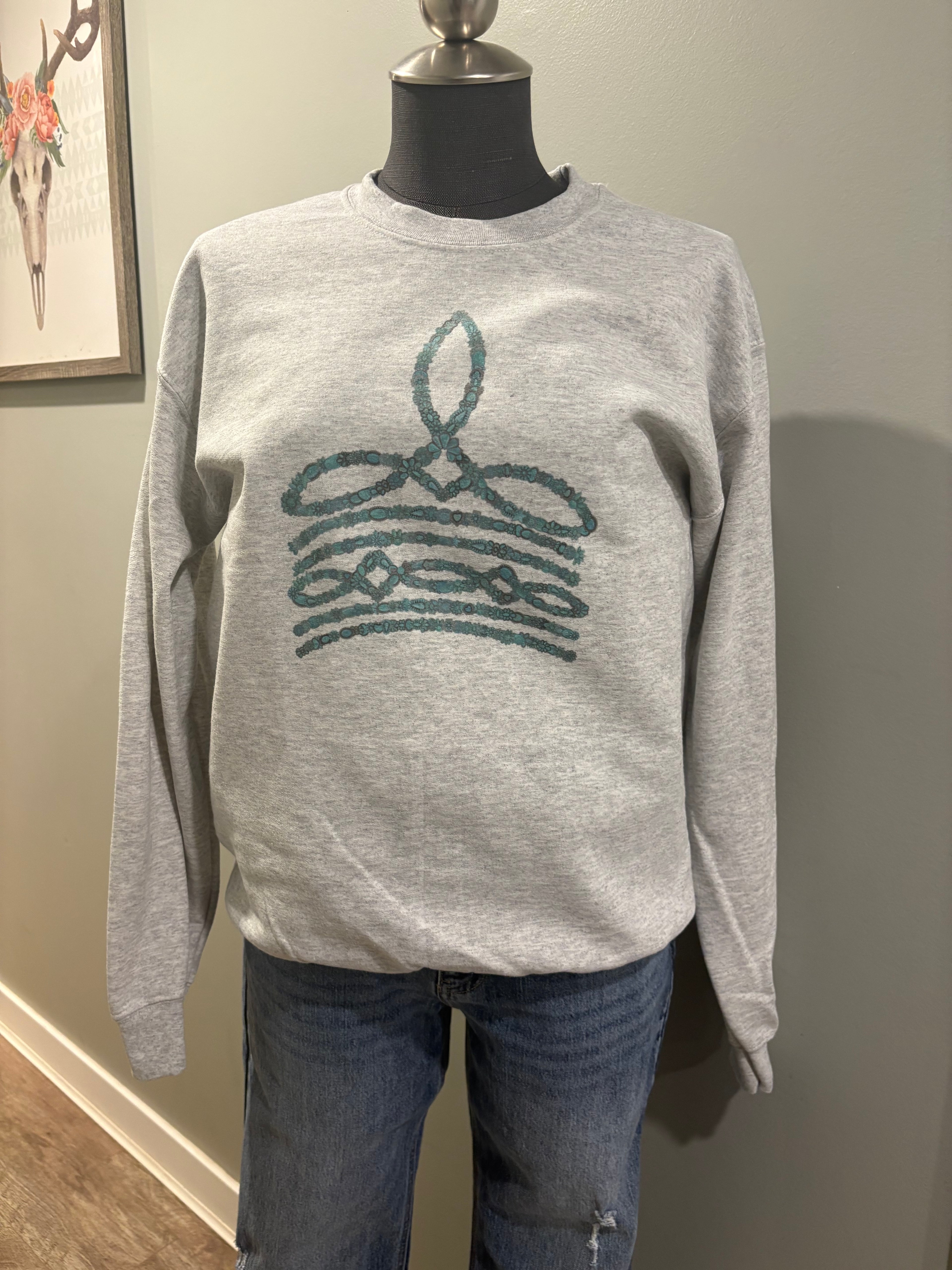Turquoise boot stitch grey crewneck sweater with western-inspired design.