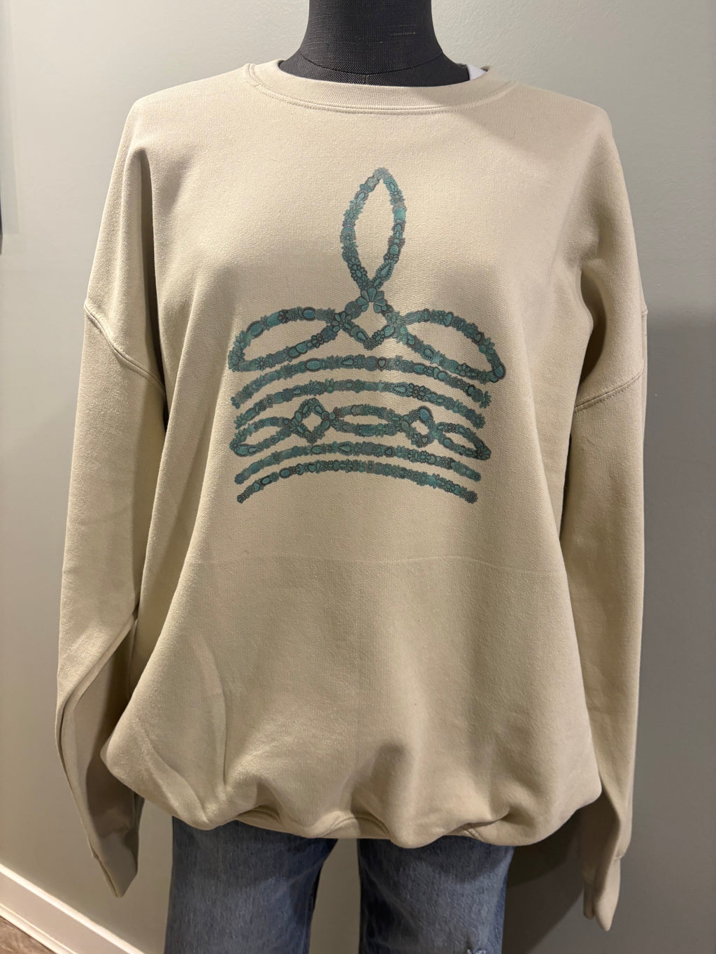Turquoise boot stitch sand crewneck sweater with western-inspired design
