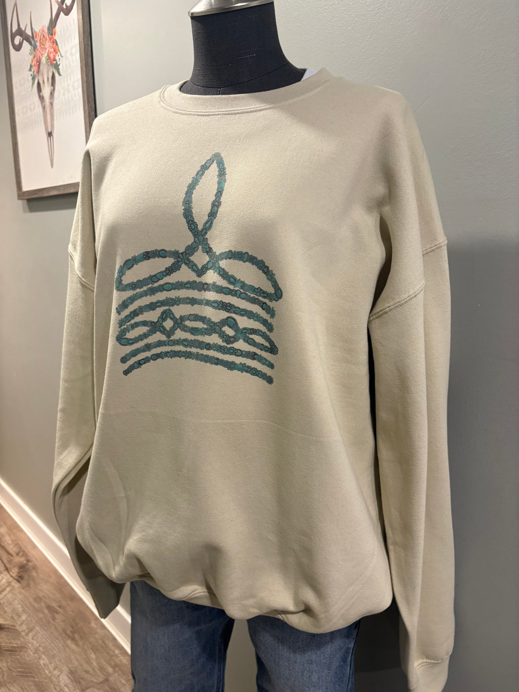 Turquoise boot stitch sand crewneck sweater with western-inspired design
